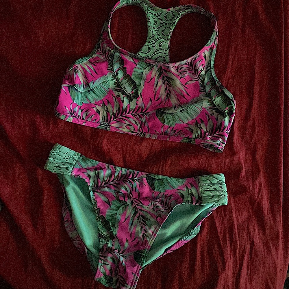 The bikini is pink with teal leaves. Size: 14-16 youth. Brand is wonder nation.